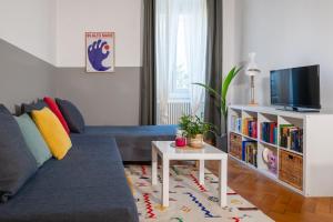 a living room with a couch and a tv at Casa Strehler in Trieste