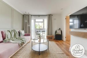 a living room with a couch and a table at Luxury 2-Bed House in Stevenage Sleeps 6 Free Parking Barefoot & Board in Shephall