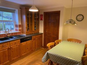 a kitchen with a table and a dining room at Stony Thwaite in Reeth +24 photos