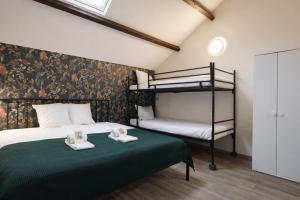 a bedroom with a bed and a bunk bed at King's Inn City Hostel Alkmaar in Alkmaar