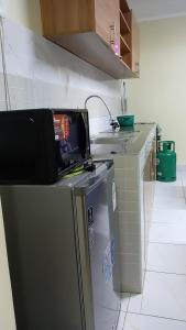 a kitchen with a refrigerator and a counter top at KiQao in Nakuru