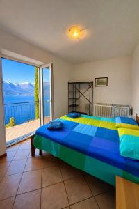 a bedroom with a bed with a view of the ocean at Villa crotto Lake View in Perledo +29 photos