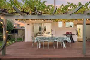 a wooden deck with a table and chairs on it at Beach House Family Friendly Enclosed Yard in Rockingham