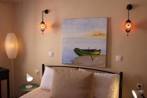 a bedroom with a bed and a painting of a boat at Nature Habitat and Artistic Room in Pentátion