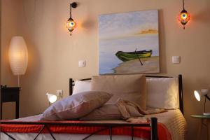 a bedroom with a bed with a painting of a boat at Nature Habitat and Artistic Room in Pentátion