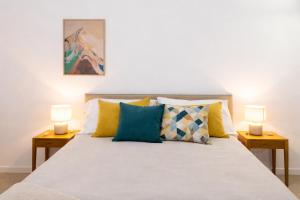 a bedroom with a bed with two lamps on tables at Erbusco Charme Apartment in Erbusco