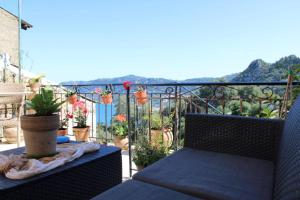 a balcony with a bench and potted plants at Nature Habitat and Artistic Room in Pentátion +50 photos