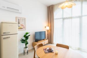 a small living room with a table and a refrigerator at Erbusco Charme Apartment in Erbusco +14 photos