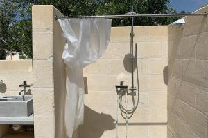 a white shower curtain hanging on a wall at Trulli Paradise Ostuni - Villa Privata con Piscina in Ostuni +70 photos