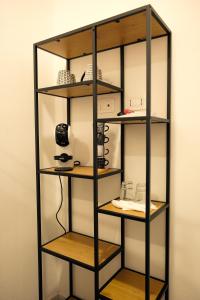 a book shelf with wooden shelves in a room at Saludu Boutique in Porto Torres
