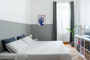 a bedroom with a bed and a book shelf at Casa Strehler in Trieste