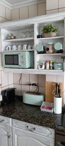 a kitchen with a counter top with a microwave at El sol y la mar in Colindres