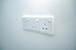 a white lightswitch on a wall on a wall at Tourist Holiday Inn in Dambulla