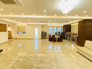 a large living room with a table and a kitchen at Hotel Ananta in Sasarām