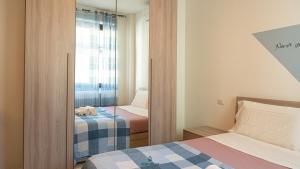 a bedroom with two beds and a mirror at I Portici - Cernobbio in Cernobbio
