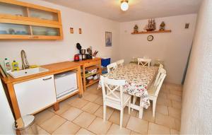 a kitchen with a table and a sink and a table and chairs at House With Heated Pool in Bribir