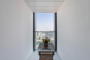 a room with a table and chairs and a window at Urban Chic - Radiant in Abu Dhabi