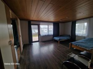 a bedroom with a bed and a wooden ceiling at Zimmer zu vermieten in Rammingen +6 photos