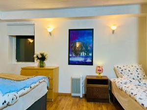 a bedroom with two beds and a table and a mirror at COZY ROOM in Helsingborg in Helsingborg