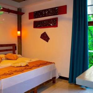 a bedroom with a bed with an american flag on the wall at Thuru Airport Apartment in Seeduwa