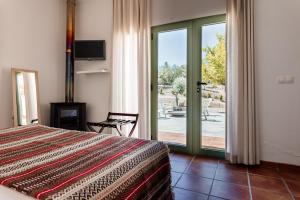 a bedroom with a bed and a sliding glass door at Vale De Ferreiros in Abrantes +67 photos