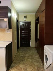 a laundry room with a black door and a washer at Apartament Piatra Neamț Centru in Piatra Neamţ