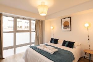 a bedroom with a bed with towels on it at Zest Vendome - Saxe Gambetta in Lyon