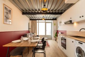 a kitchen and dining room with a table and a washer at Zest Vendome - Saxe Gambetta in Lyon +8 photos