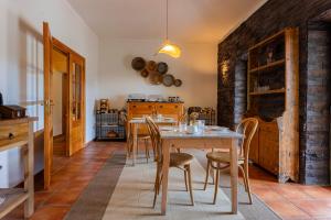 a kitchen with a table and chairs in a room at Vale De Ferreiros in Abrantes