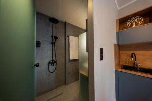 a bathroom with a shower and a sink at Gaia Apartments in Mytilene +127 photos