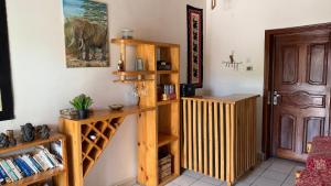 a room with wooden shelves and an elephant on the wall at Volcano View in Ruhengeri