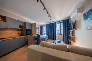 a living room with a couch and a kitchen at Gaia Apartments in Mytilene