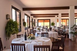 a dining room with white tables and chairs at Torre Sant'Irene Club in Sant'Irene-Briatico