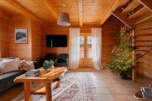 a living room with a christmas tree and a couch at Domki Bystre in Baligród
