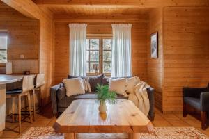 a living room with a couch and a table at Domki Bystre in Baligród