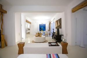 a white living room with a white couch and a table at Maison Haute Mykonos in Ornos