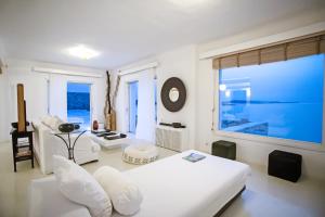 a white room with a bed and a large window at Maison Haute Mykonos in Ornos +69 photos