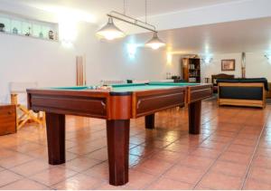 a pool table in the middle of a living room at Green Villa Gerês in Geres