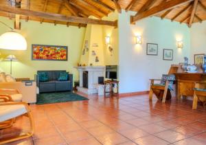 a living room with a couch and a fireplace at Green Villa Gerês in Geres +27 photos