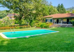 a swimming pool in the yard of a house at Green Villa Gerês in Geres