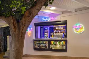 a bar with neon signs and a tree at Begovina in Marmaris