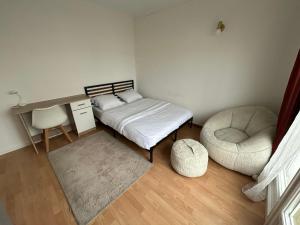 a bedroom with a bed and a chair and a desk at Made 1 in Le Mans