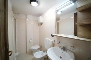 a bathroom with a sink and a toilet and a mirror at Torre Sant'Irene Club in Sant'Irene-Briatico +11 photos