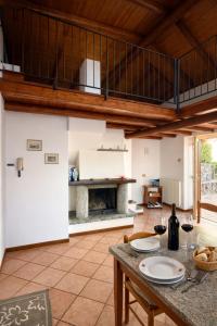 a living room with a table and a fireplace at Villa crotto Lake View in Perledo