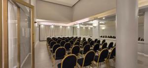 a conference room with black chairs and a mirror at Gran Hotel Buenos Aires in Buenos Aires