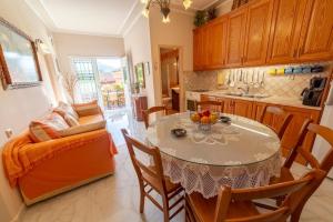 a kitchen with a table and a couch in a room at 2-BR Apartment by the Sea in Paramonas