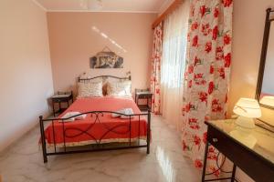 a bedroom with a red bed and a window at 2-BR Apartment by the Sea in Paramonas