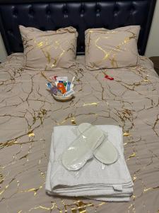 a bed with a tray of toys and a pair of shoes at Lex Place Syokimau in Syokimau +19 photos