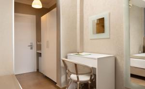 a small room with a white desk and a chair at Begovina in Marmaris +71 photos