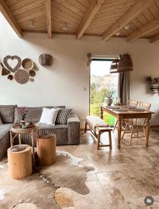 a living room with a couch and a table at Owczarnia Tatry in Bukowina Tatrzańska